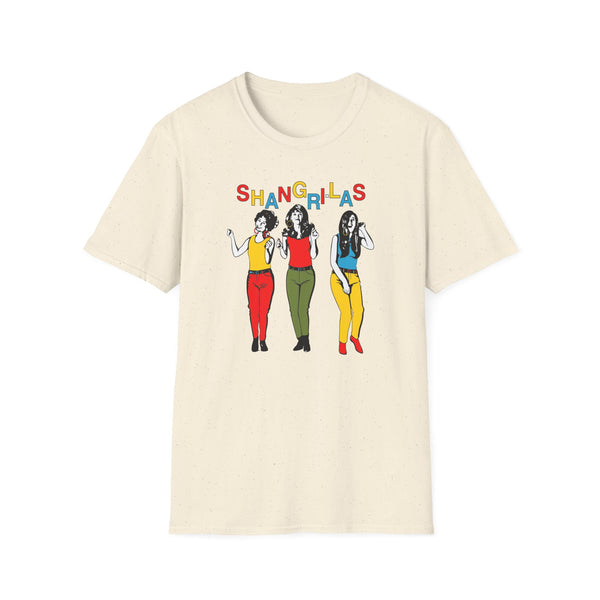 Cream t-shirt with "Shangrila's" text above illustration of three women in colorful outfits.